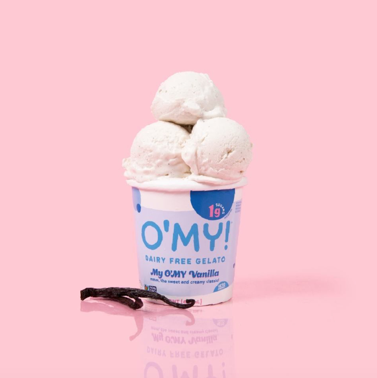 Three scoops of O'MY dairy free gelato in My O'My Vanilla against a pink background with two vanilla beans on the side. 