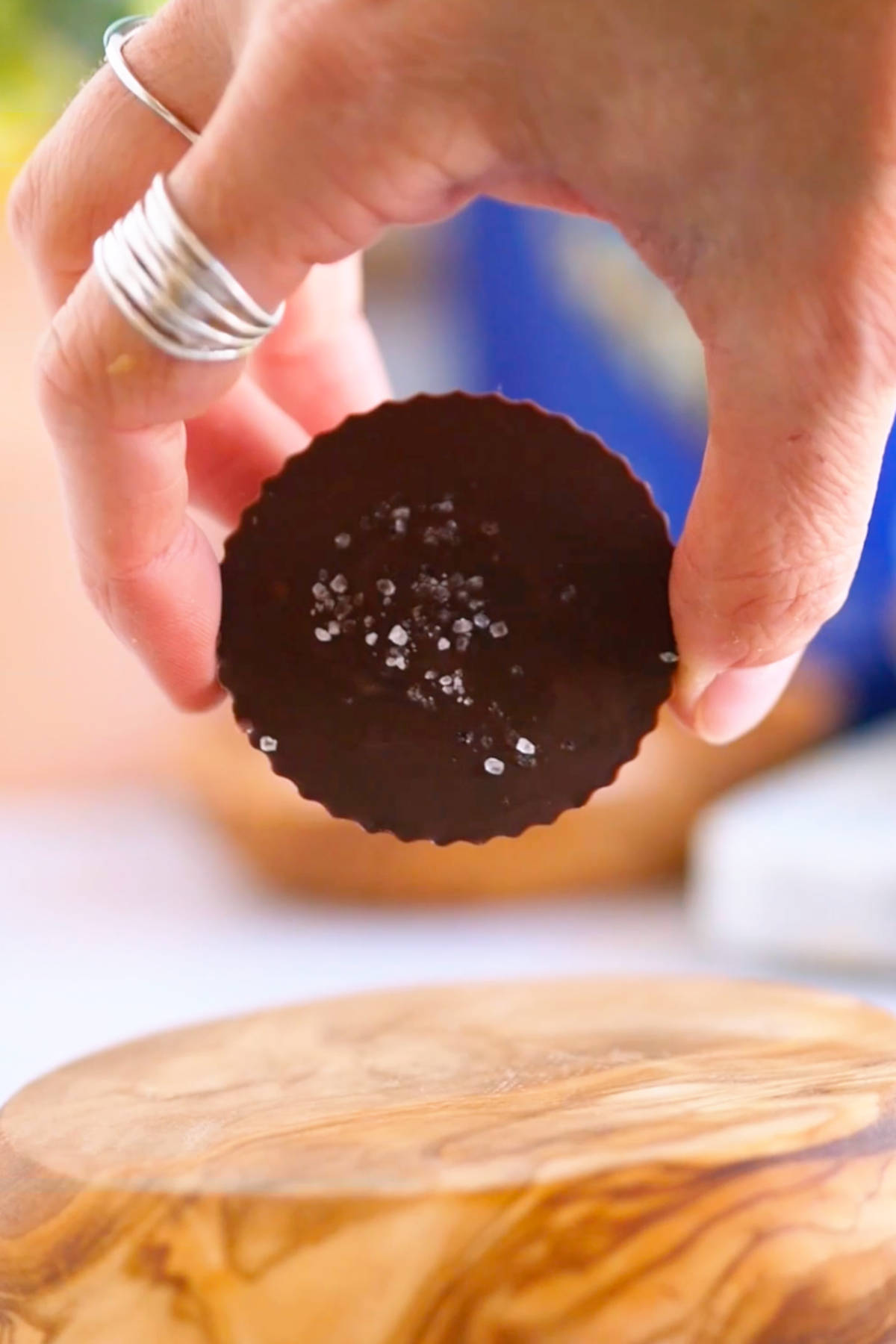 A hand holding a homemade vegan peanut butter cup.