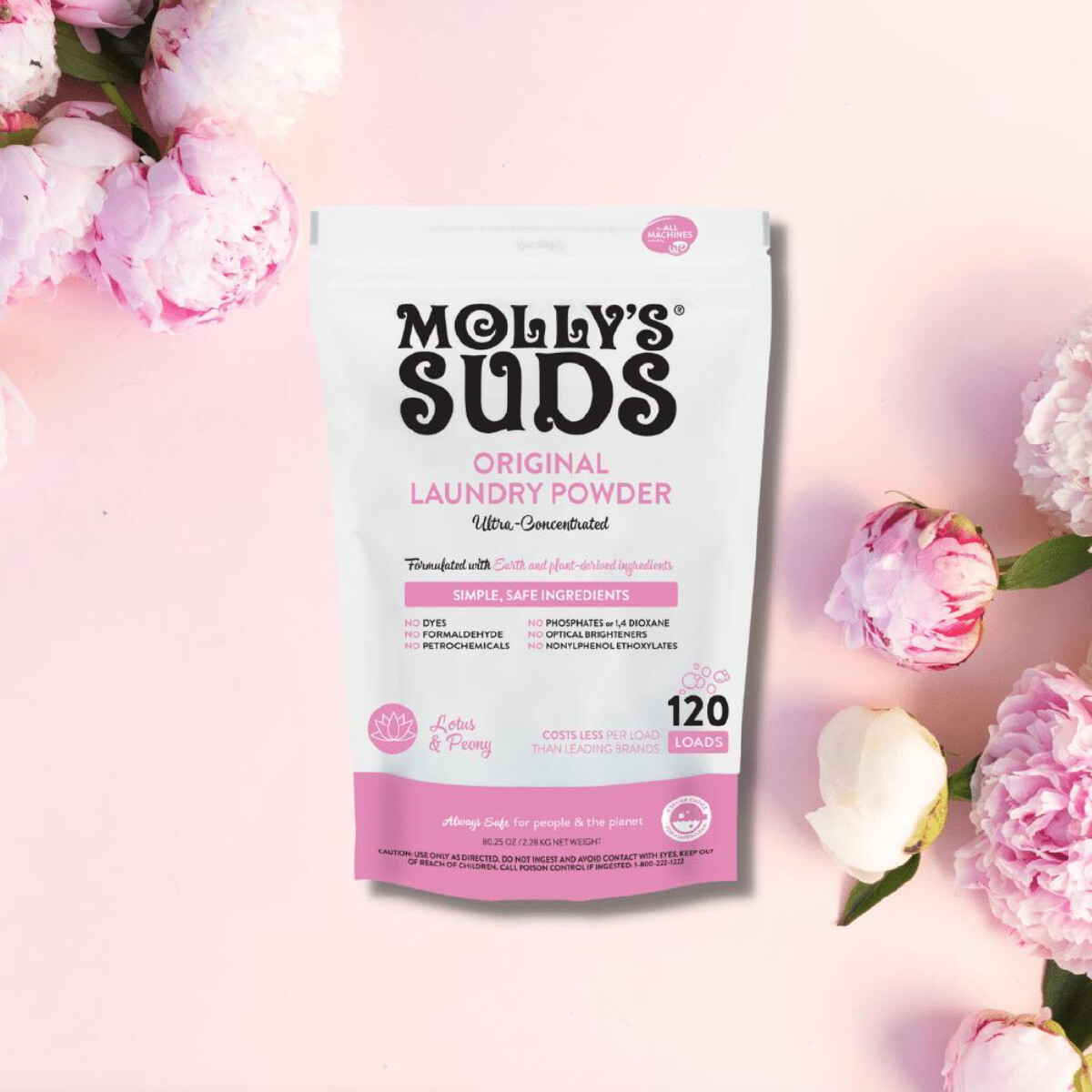 A white and pink package of Molly's Suds laundry powder in Lotus & Peony against a pink background with peonies. 
