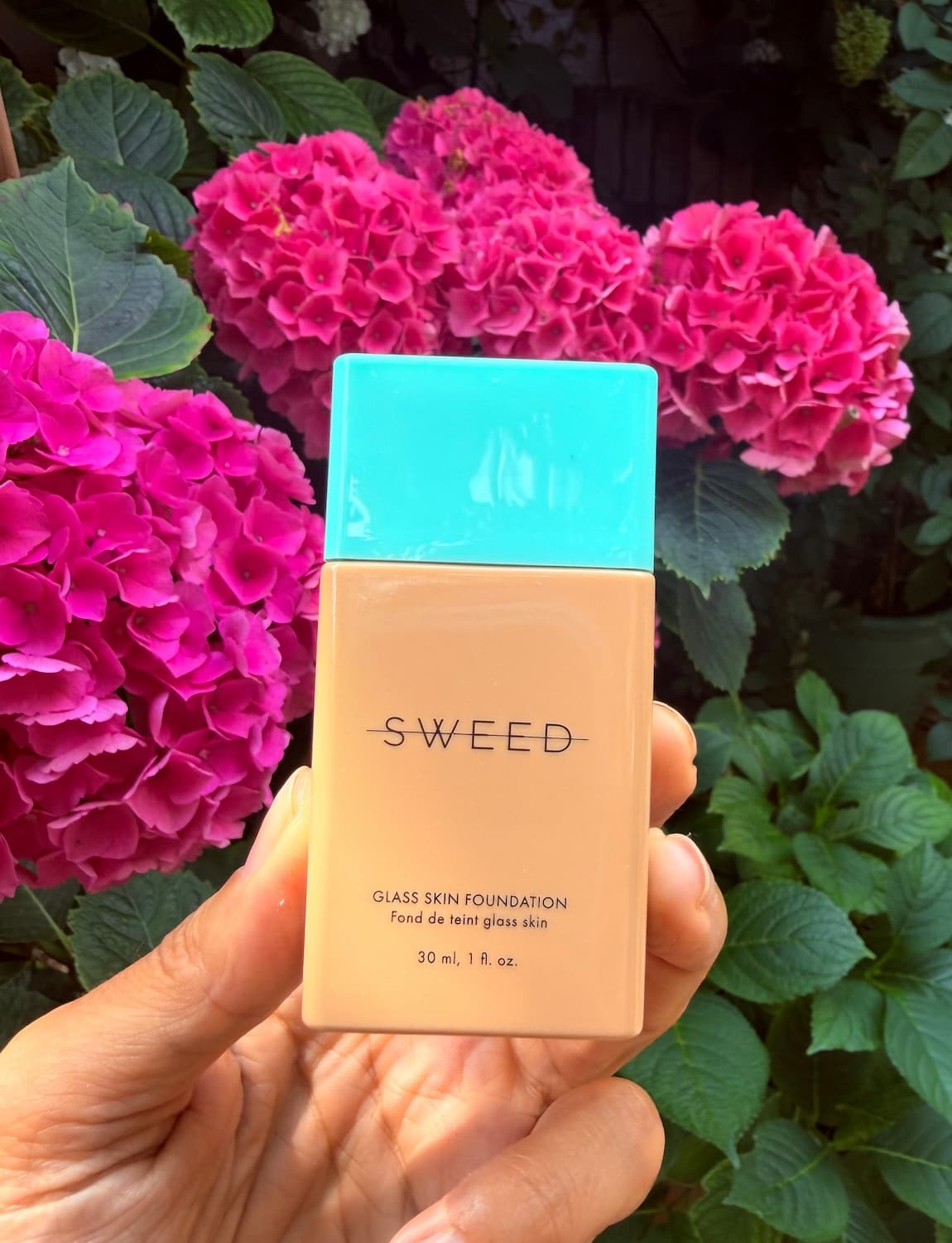 hand holding mini bottle of Sweed vegan cruelty free foundation