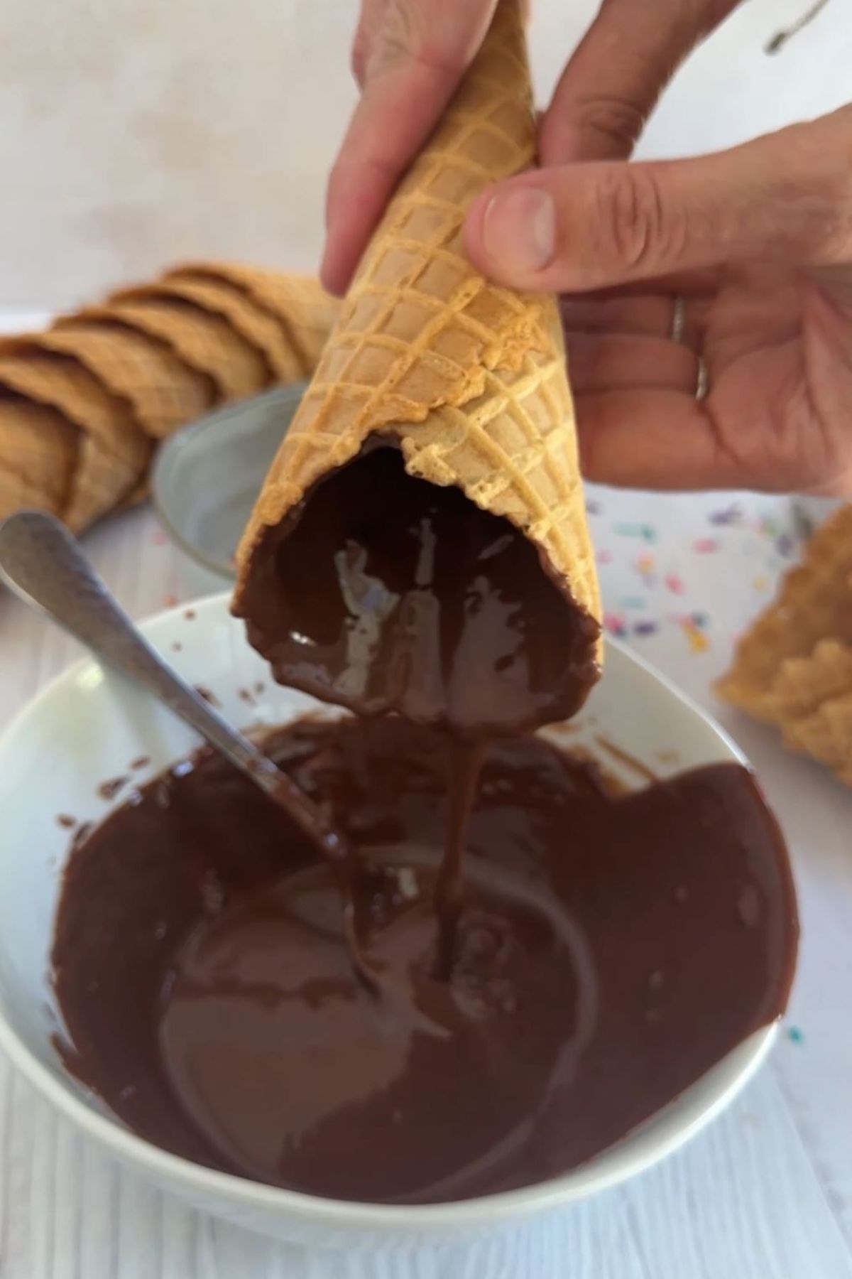 An ice cream cone coated with melted chocolate.