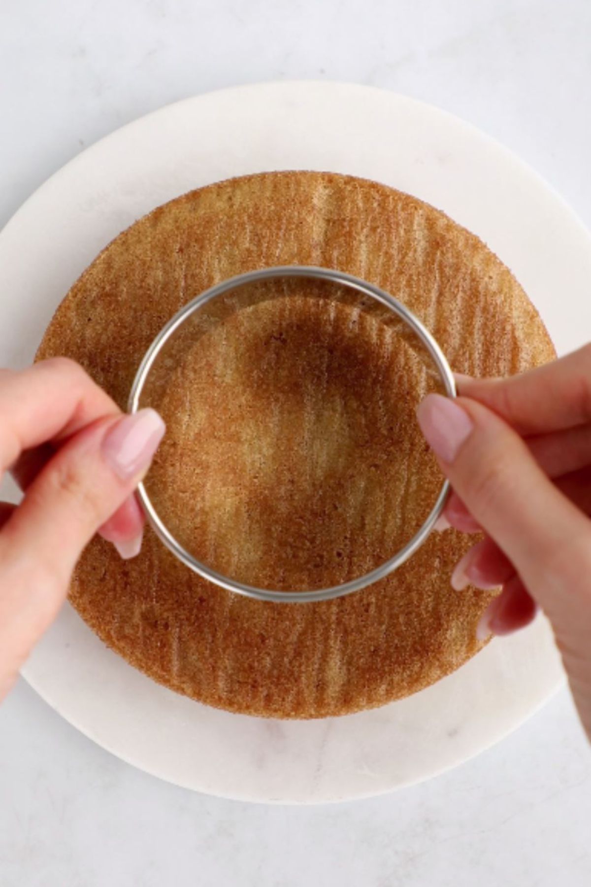 A mold used to cut out a tier of a vegan birthday cake.