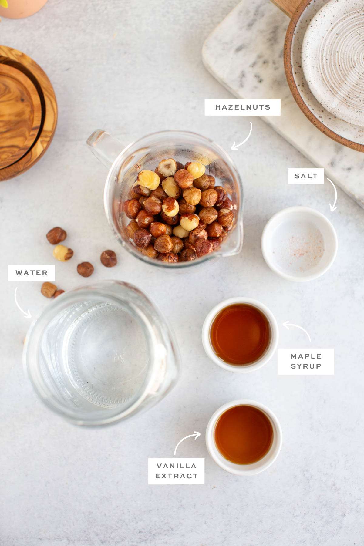 Gathered ingredients for the vegan coffee creamer recipe in individual bowls with labels.