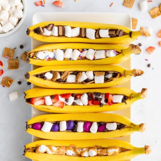 Campfire banana boats, lined up on a plate.