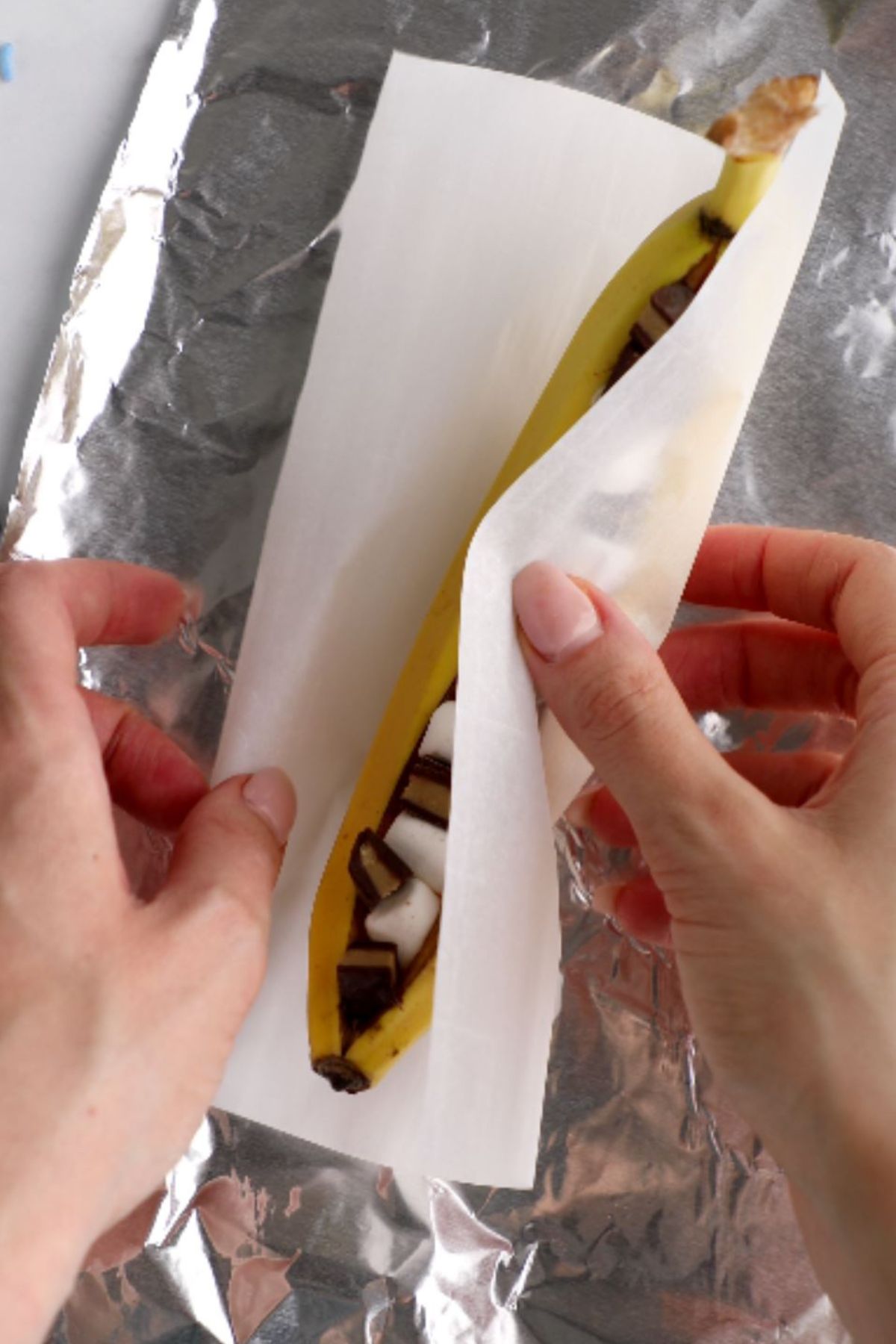 A campfire banana boat wrapped in parchment paper and foil.