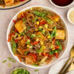 A bowl of vegan glass noodles with tofu and veggies.