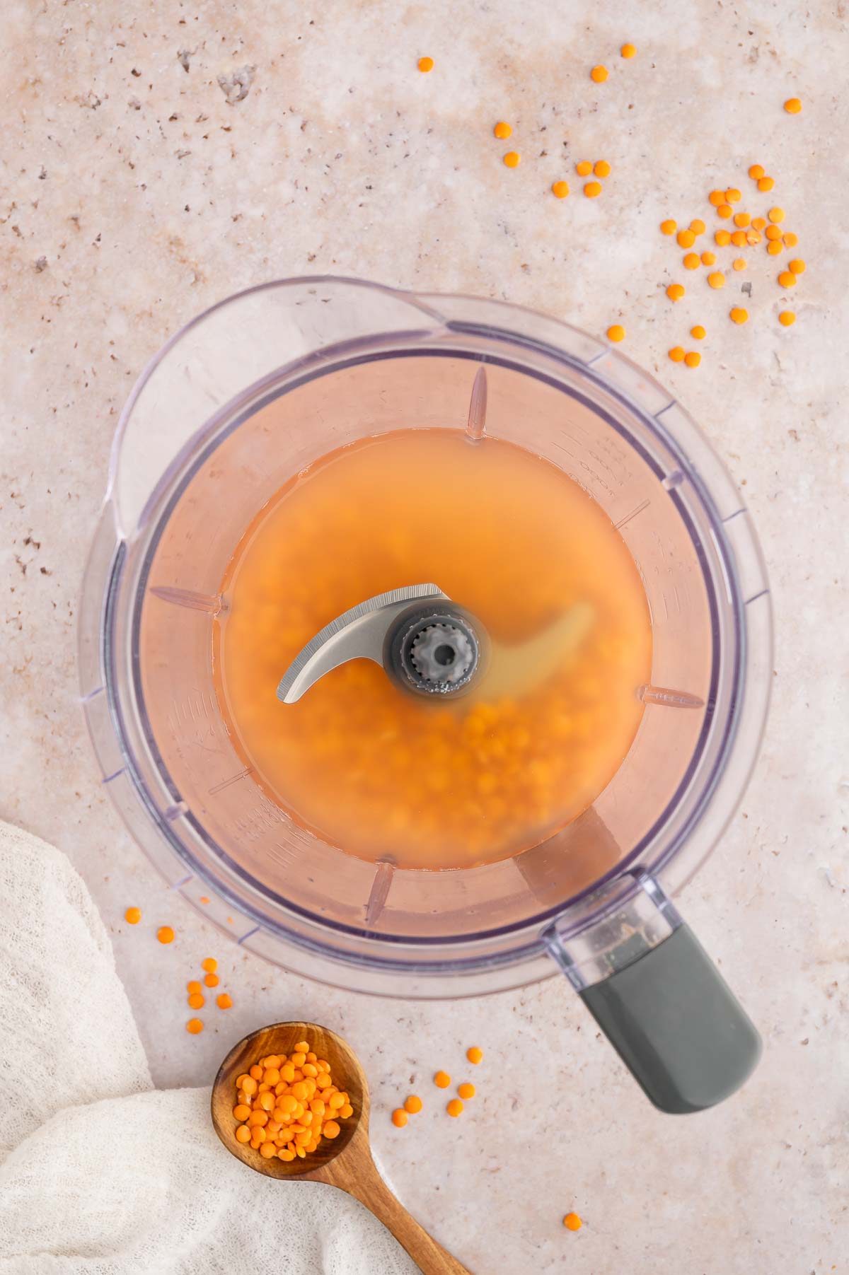 Red lentils and water in a blender.