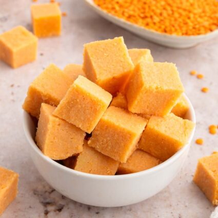 A bowl of red lentil tofu cubes in a white bowl.
