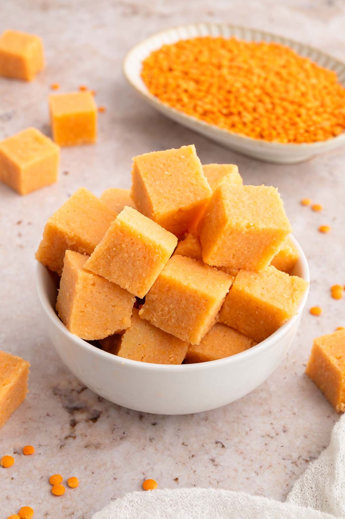 A bowl of cubed red lentil tofu.