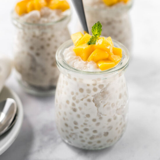 A few jars of vegan tapioca pudding topped with diced mango.