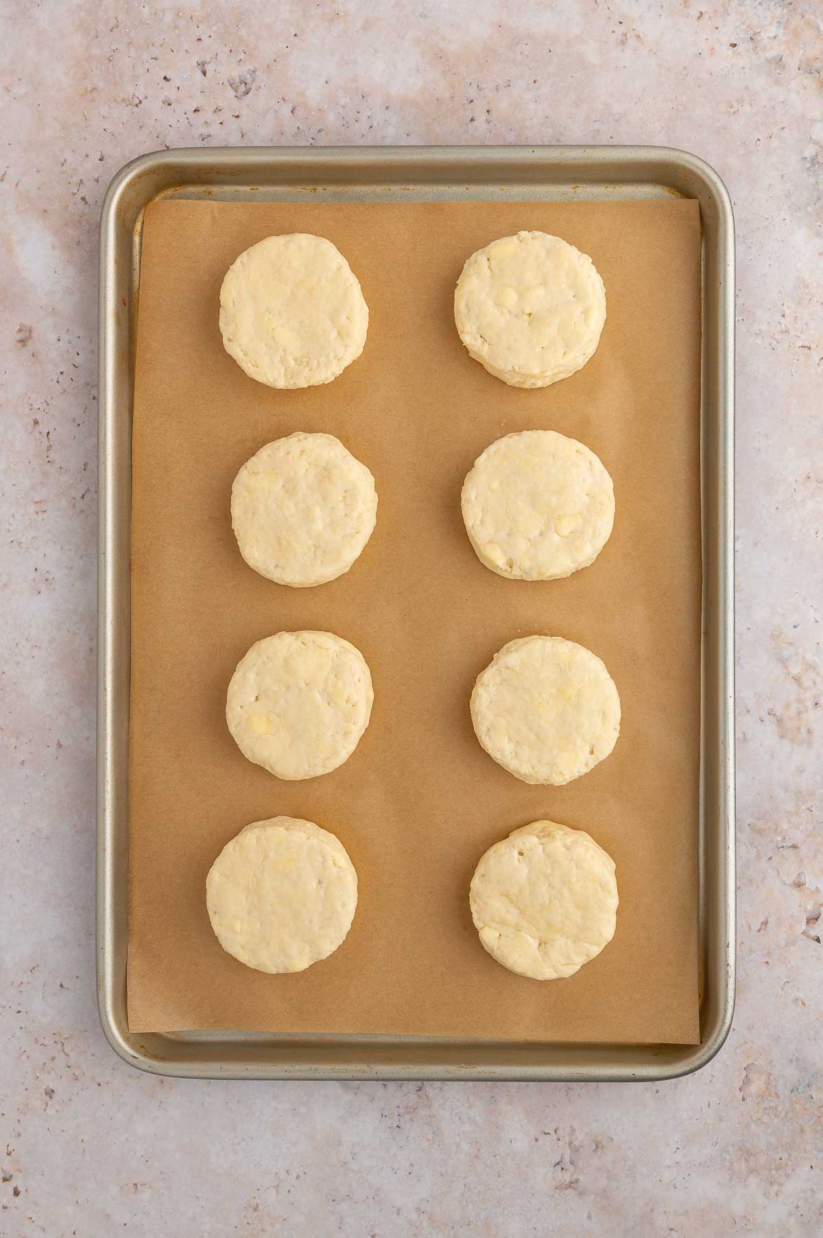 Unbaked vegan biscuits on a baking sheet.