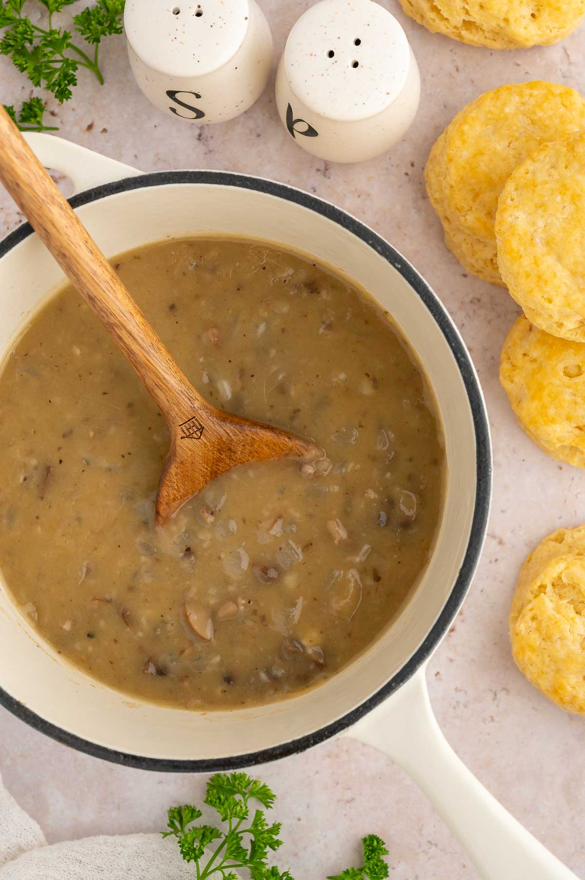 A pot of vegan gravy with a spoon.