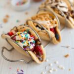 A colorful pancake taco in a taco holder.