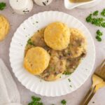 Vegan biscuits and gravy on a plate with garnish.