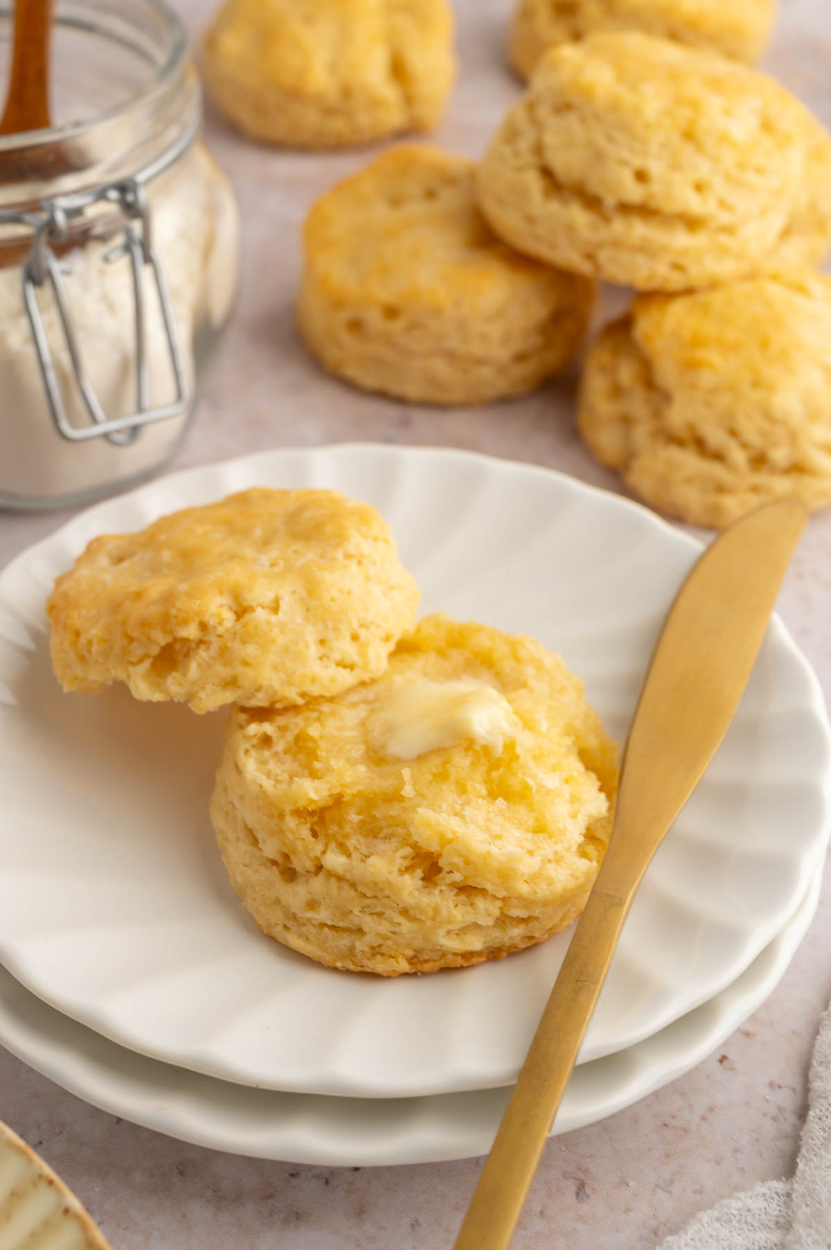 A plate of vegan biscuits with a pat of plant-based buttter.