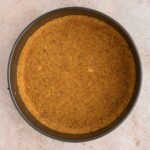 Vegan graham cracker crust in a springform pan.