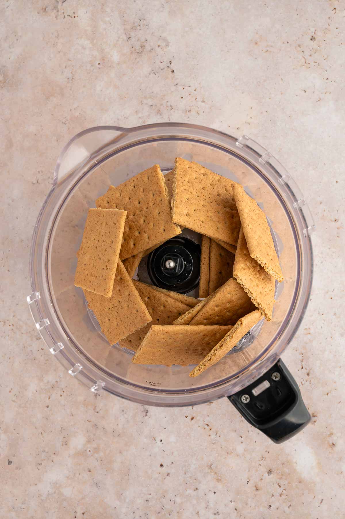 Graham crackers placed into a food processor.