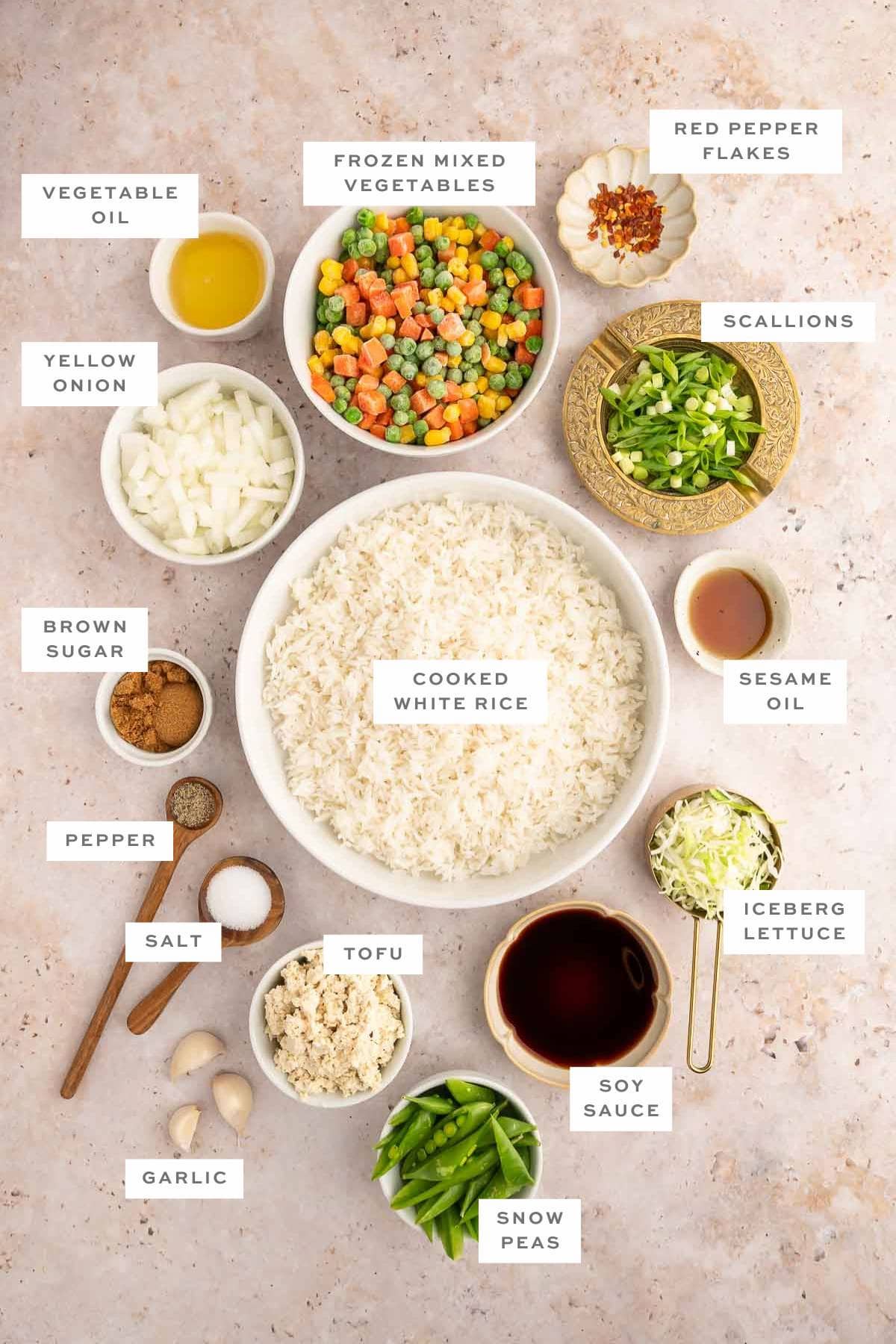 Gathered ingredients to make vegan fried, measured out into individual bowls with labels.