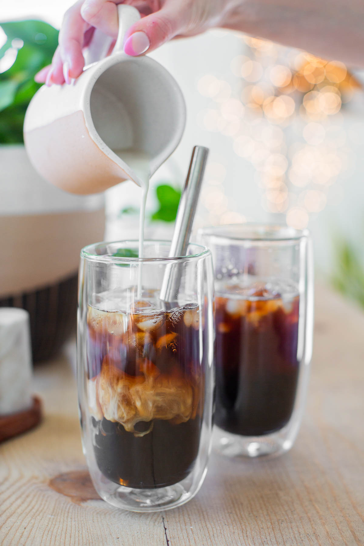 Vegan milk poured into a coffee boba drink.