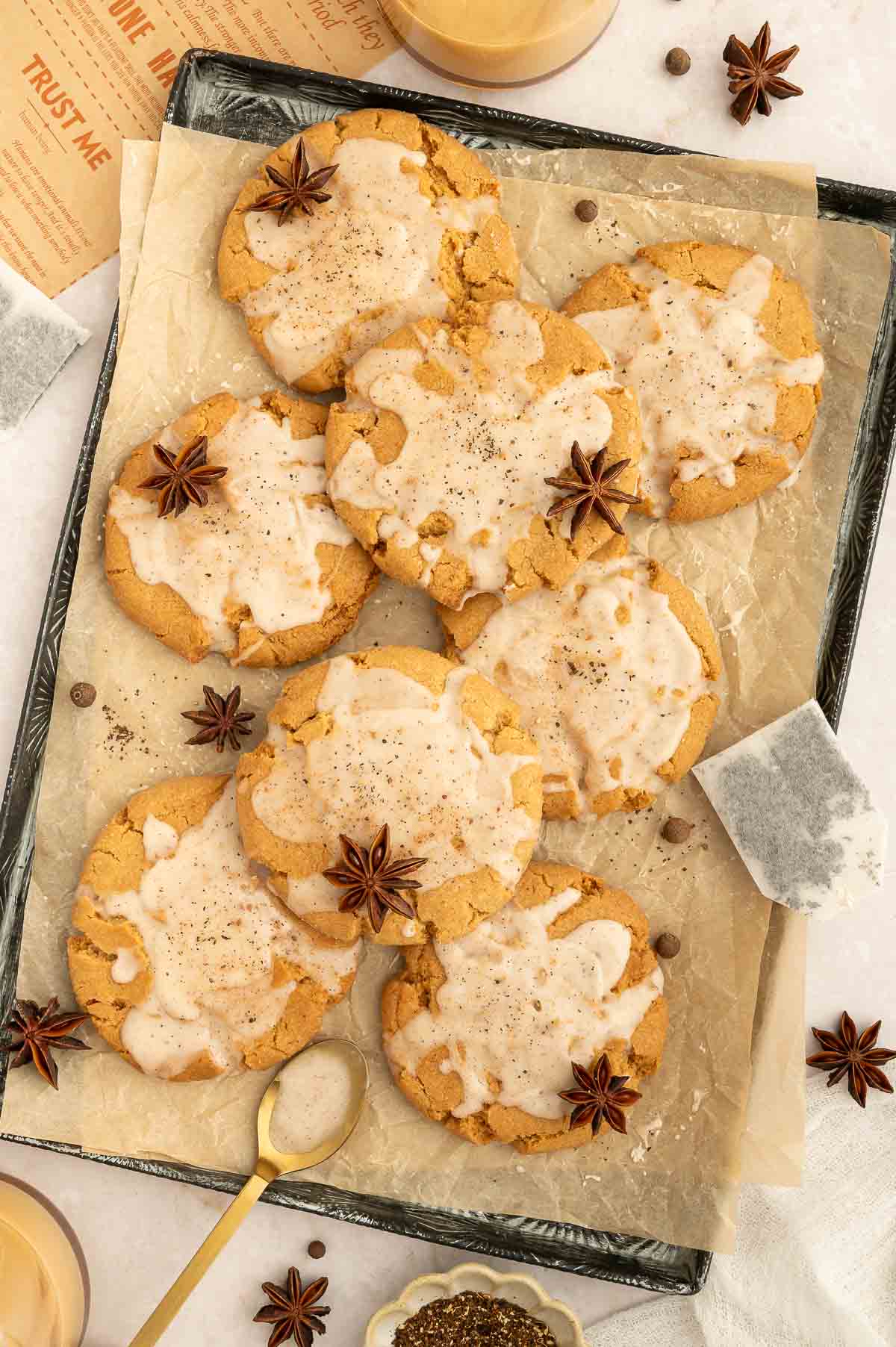 Iced vegan chai cookies on a baking sheet.