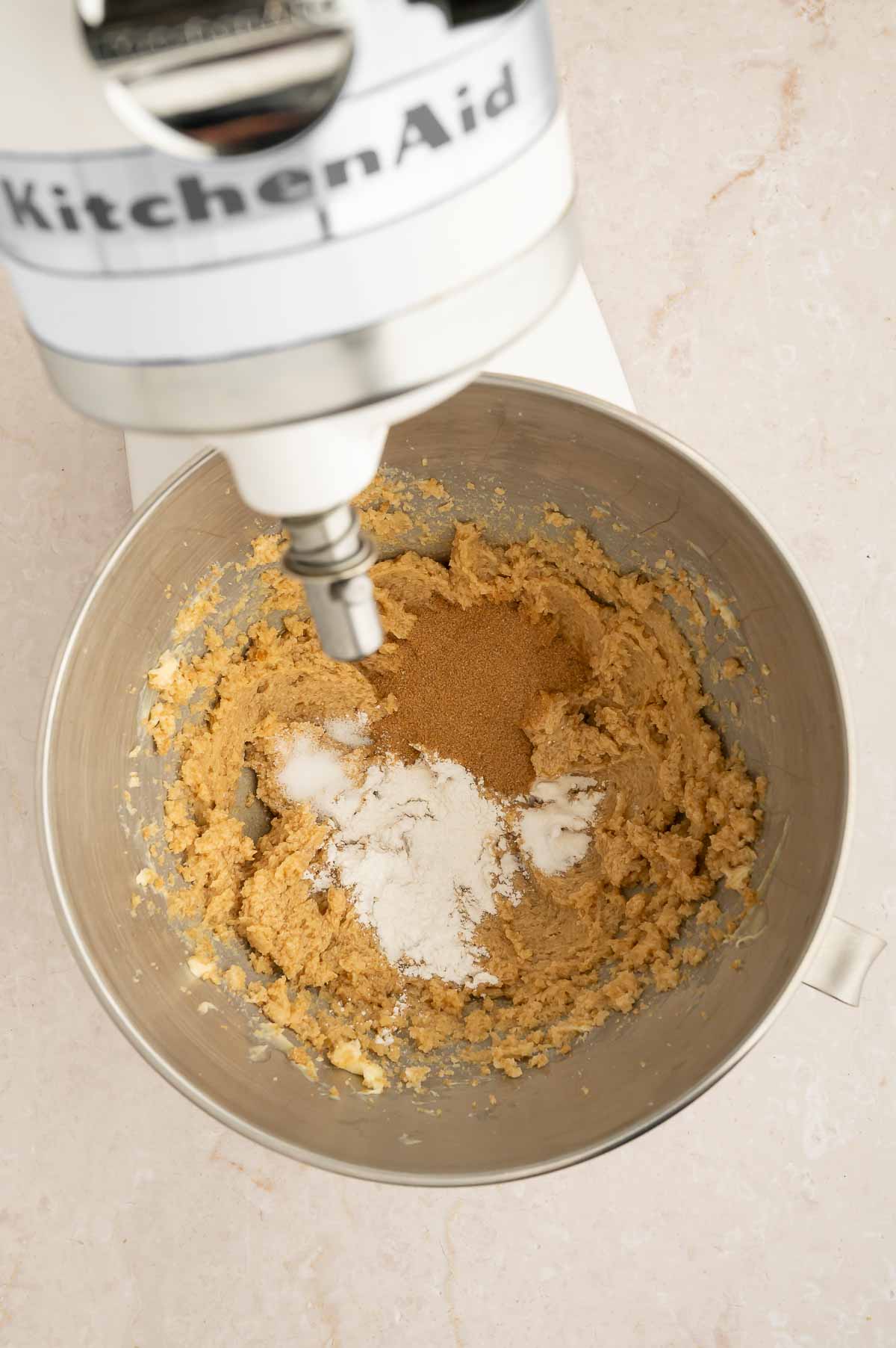 Vegan chai cookie dough being mixed in a stand mixer.