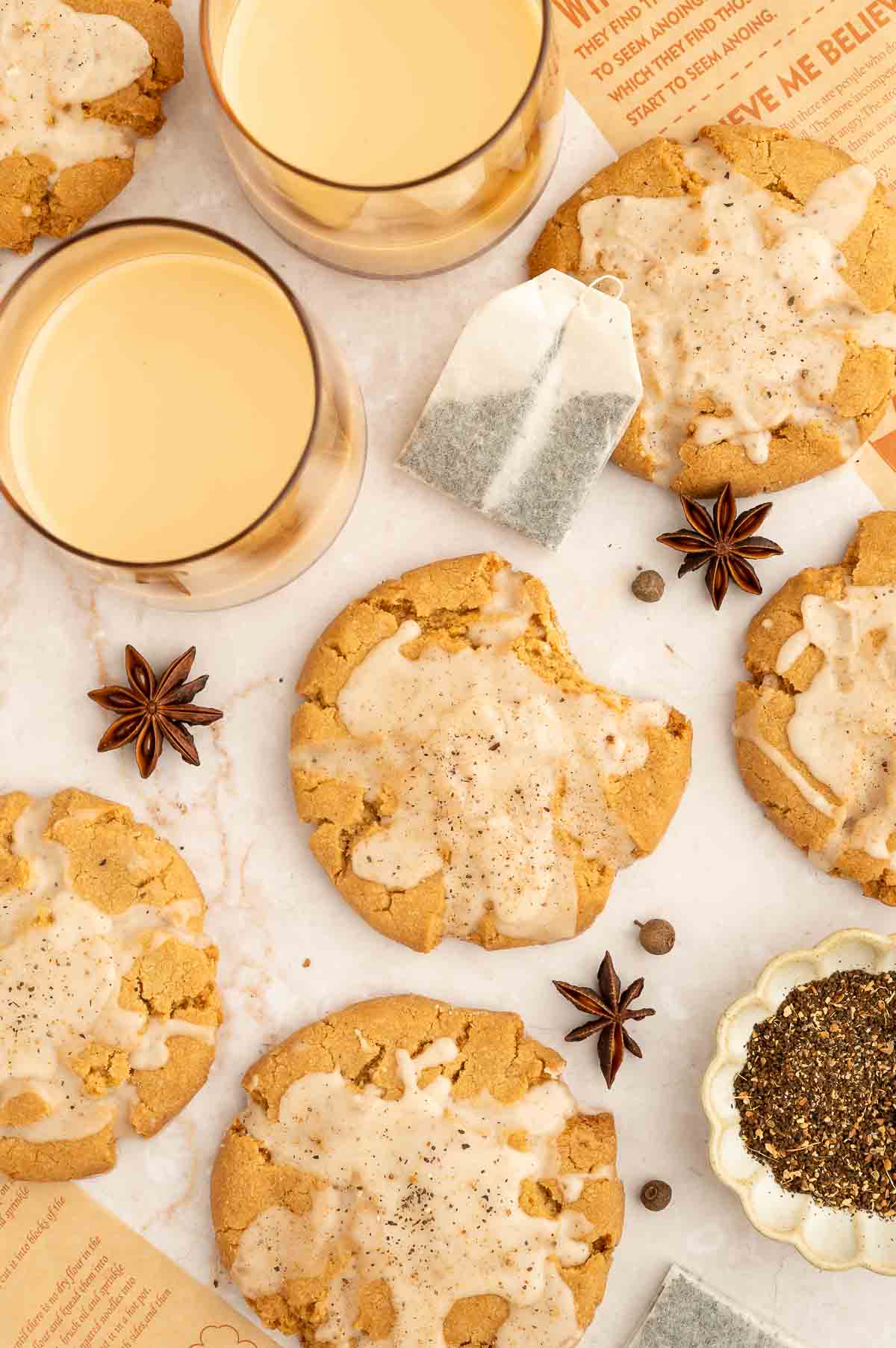 A spread of iced vegan chai cookies with star anise.