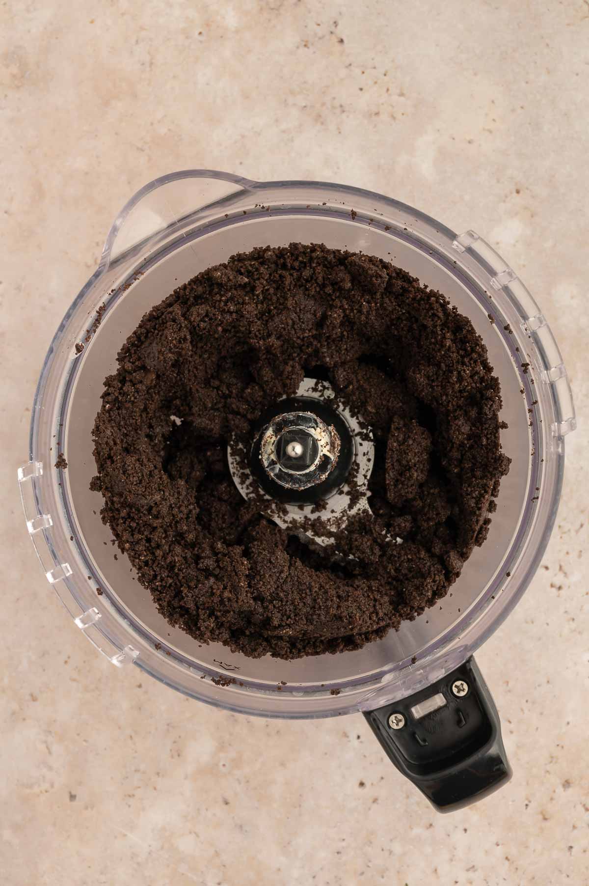 Crumbled oreo cookies in a food processor.