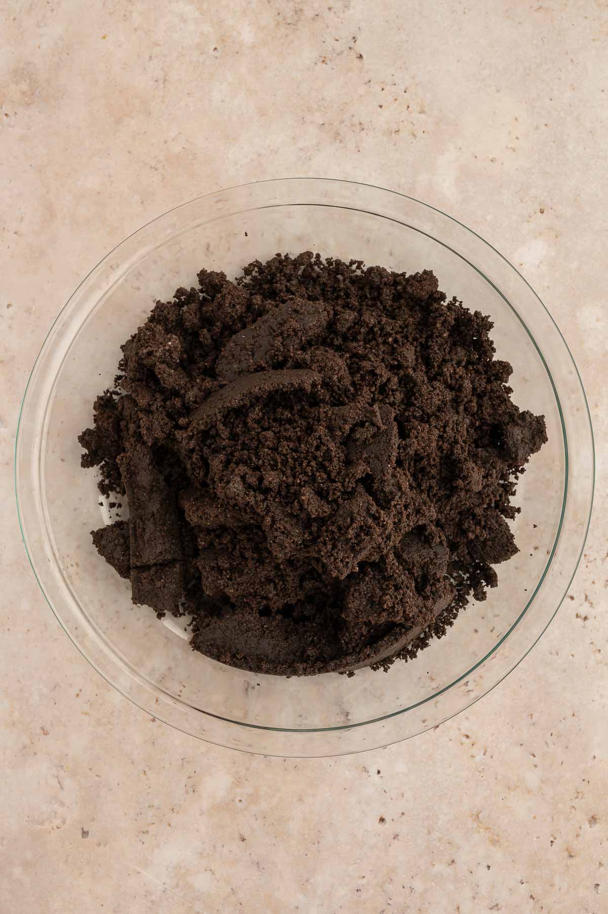 Crumbled Oreo cookies in a bowl.