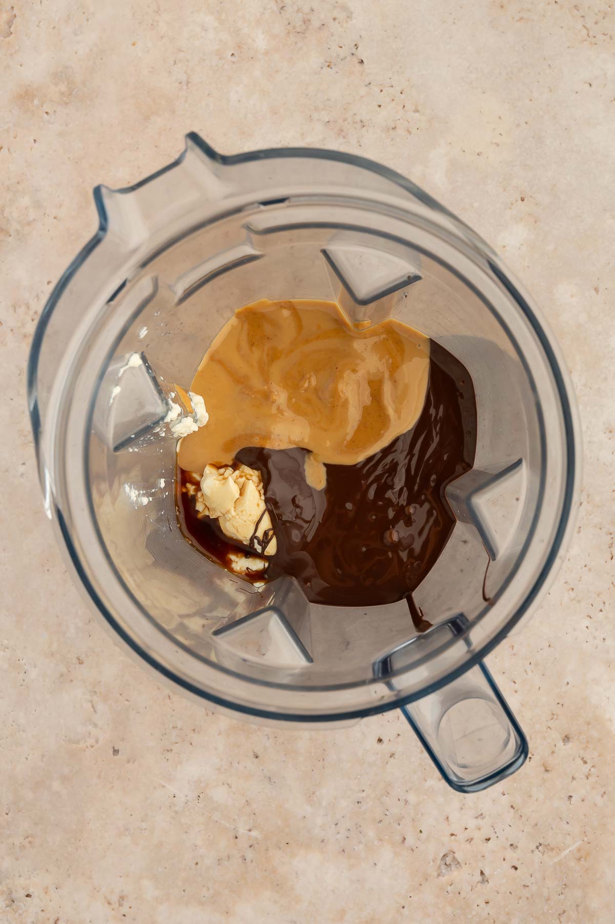 Ingredients to make a vegan chocolate peanut butter pie in a blender.
