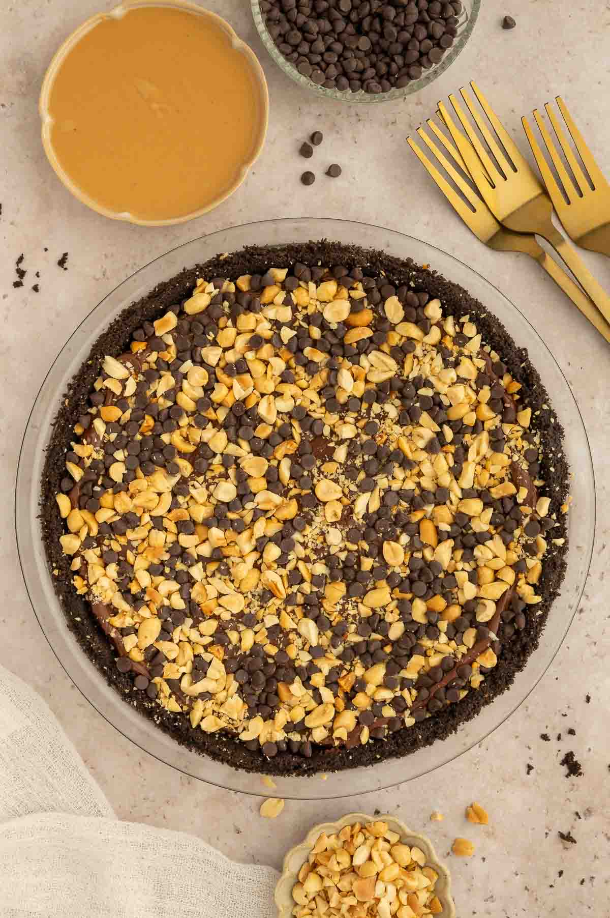 A vegan chocolate peanut butter pie topped with nuts.