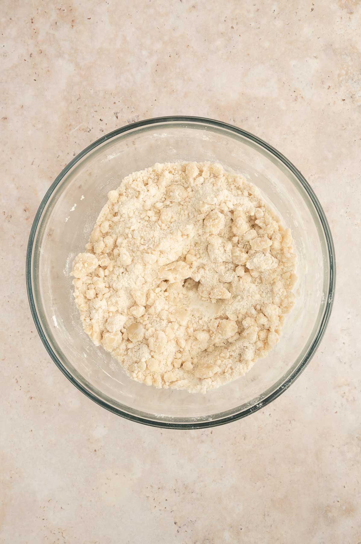 Dry and wet ingredients whisked together to form a sandy, clumpy texture.