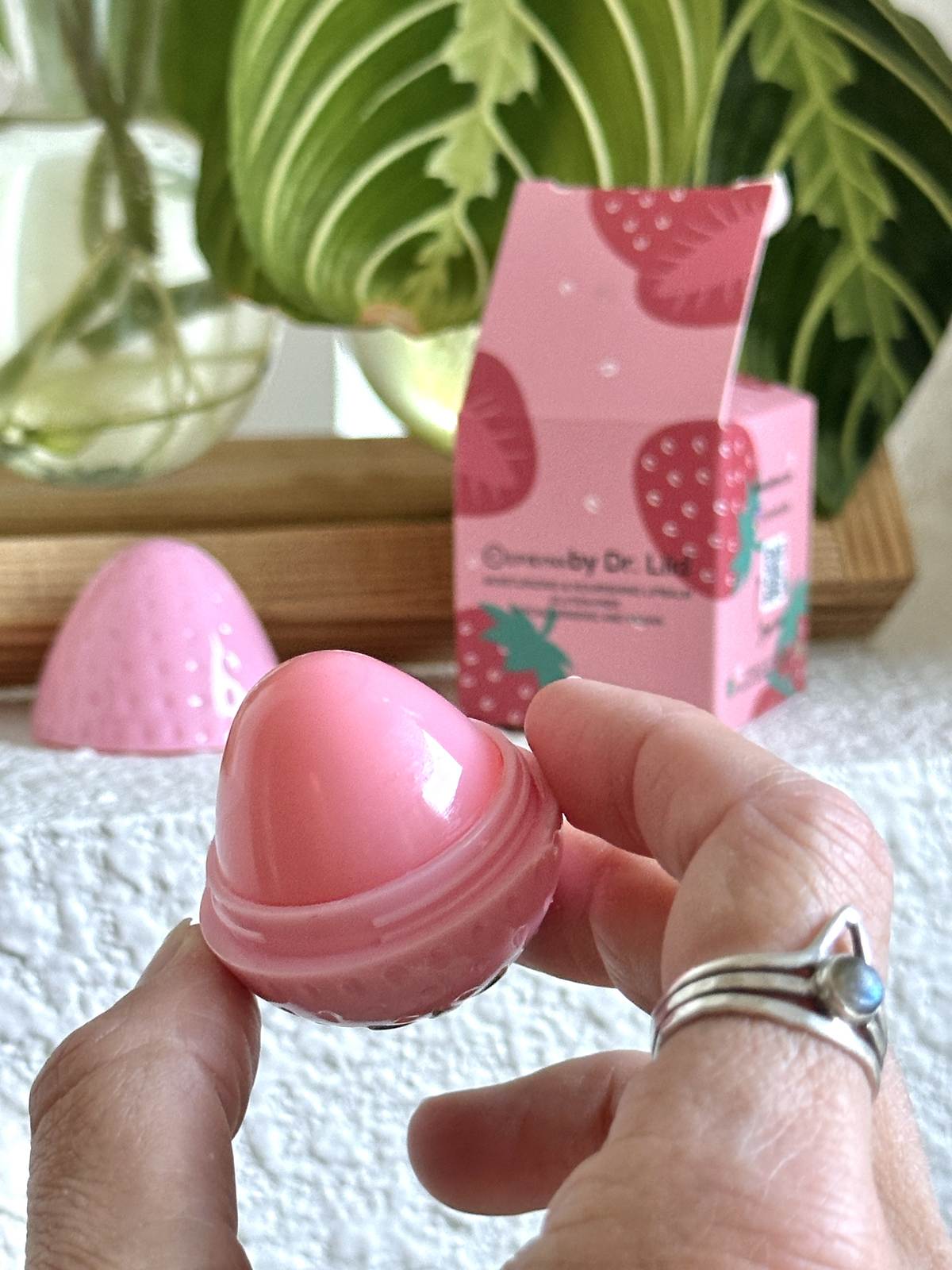 hand holding vegan lip balm by Epilynx by Dr. Liia