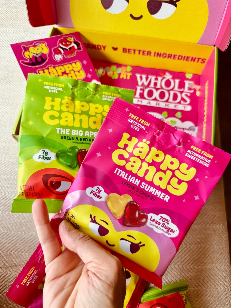 hand holding bag of happy candy vegan gummies
