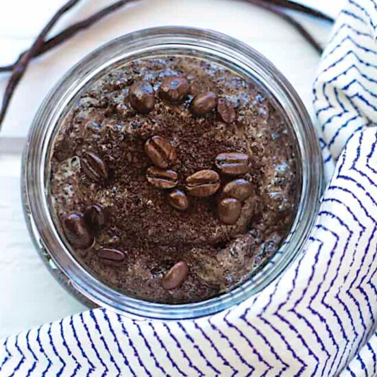 A glass jar filled with diy coffee body scrub.