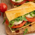 Vegan caprese sandwiches served on a French baguette and drizzled with balsamic glaze.