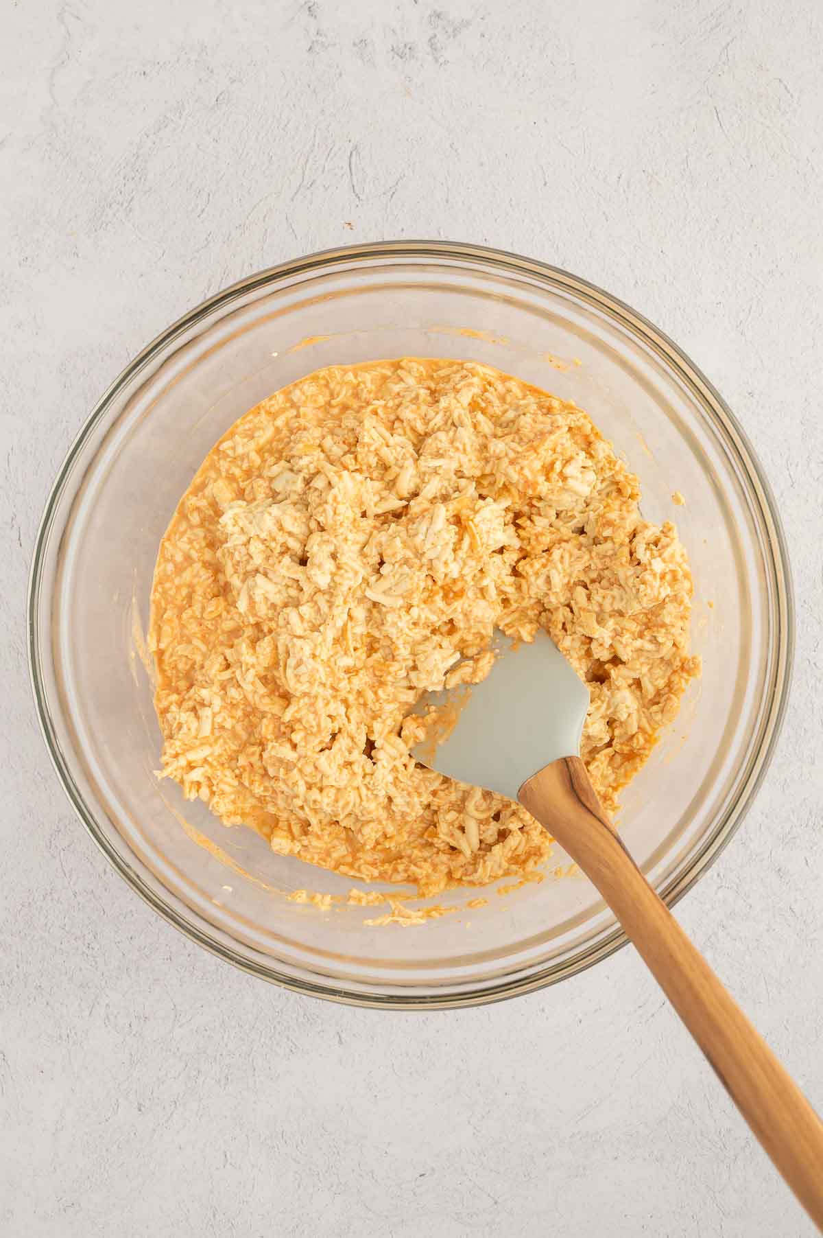 Seasoned tofu mixture in a glass bowl, used as vegan crab for poke bowls with spicy mayo and shredded tofu.