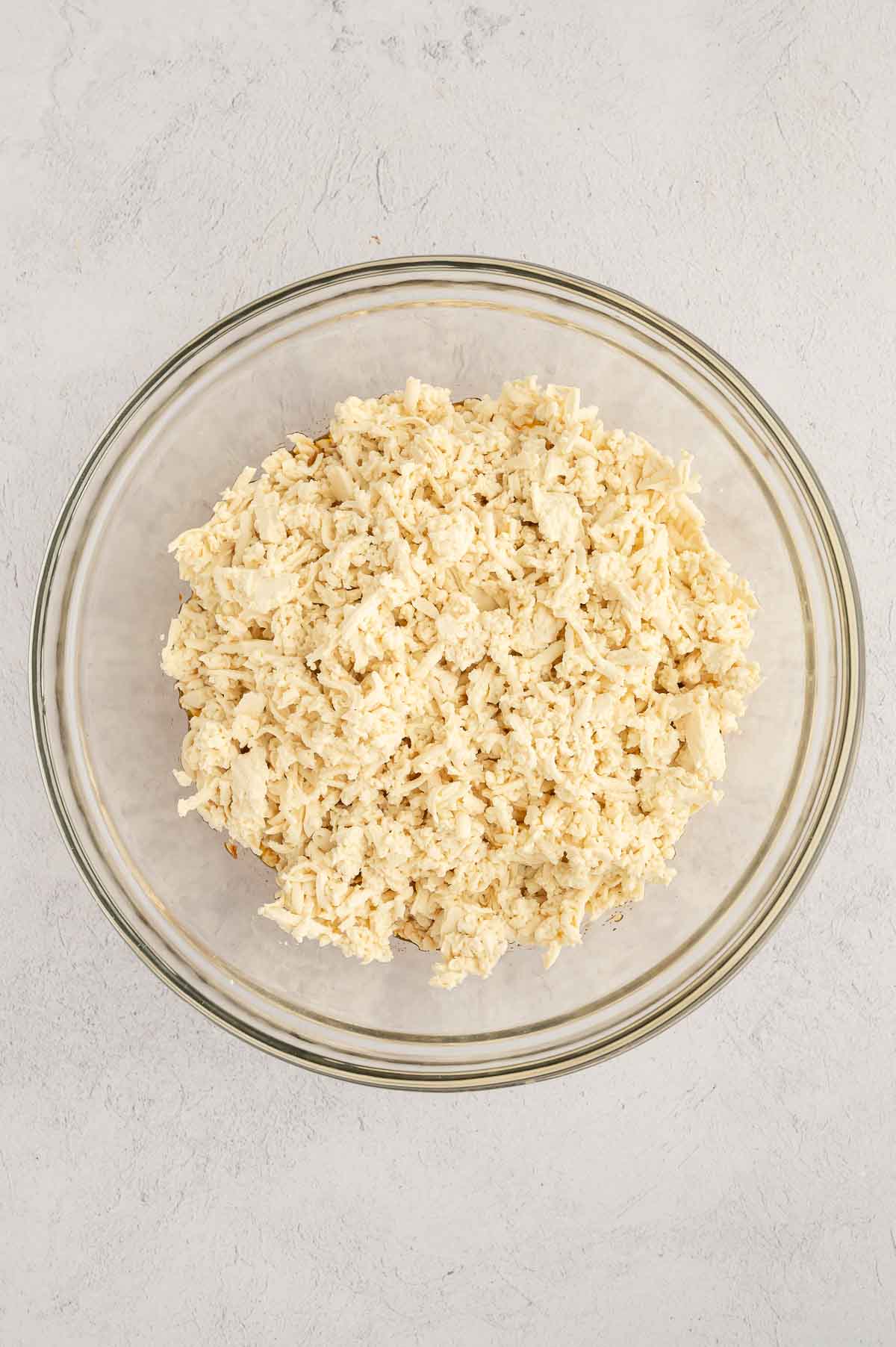 Bowl of shredded tofu ready to be seasoned for vegan poke bowl crab filling.