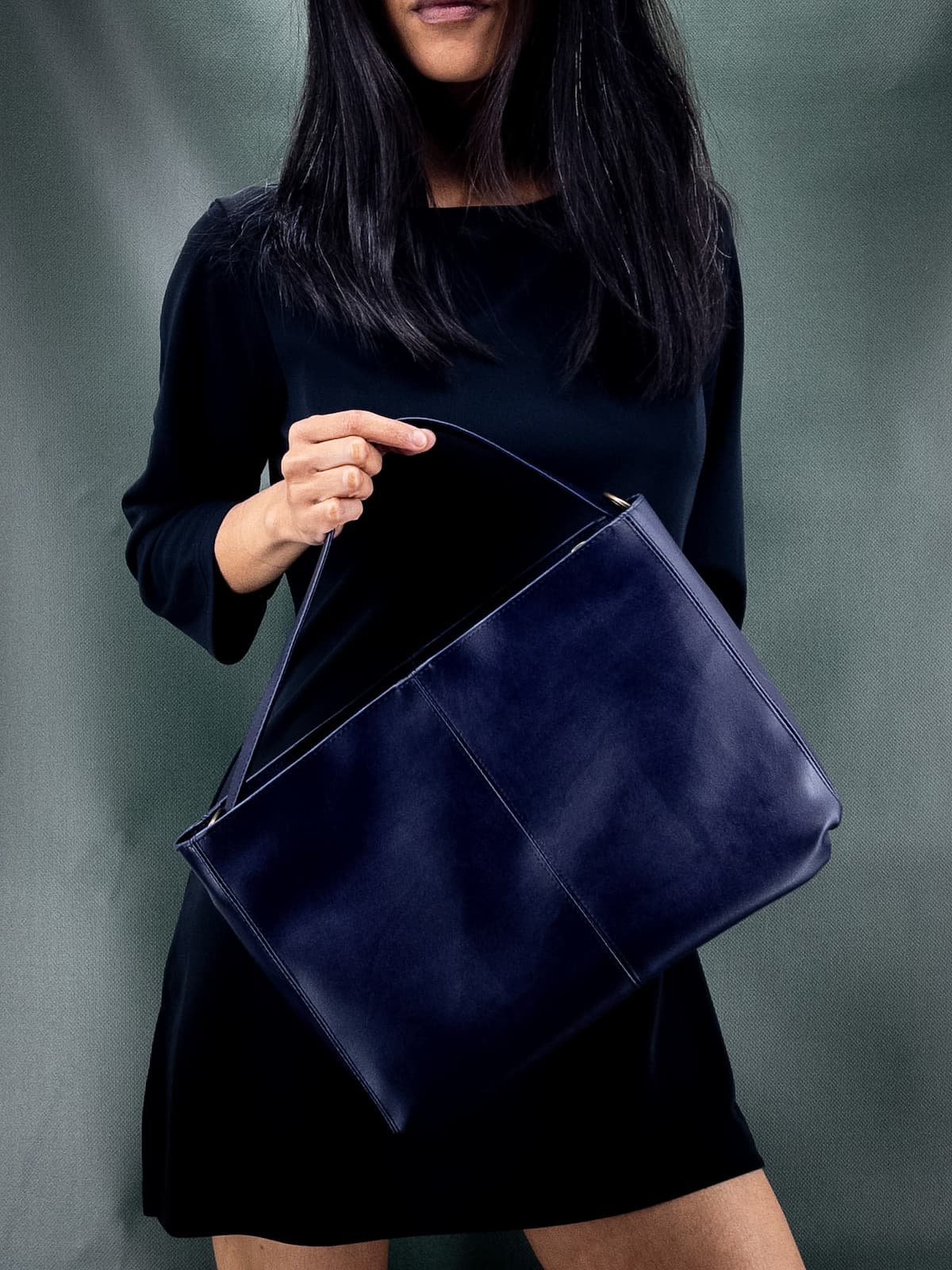 woman holding a lubay blue vegan handbag