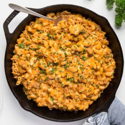 Cheesy vegan hamburger helper (or vegan cheeseburger casserole) in a cast iron skillet.