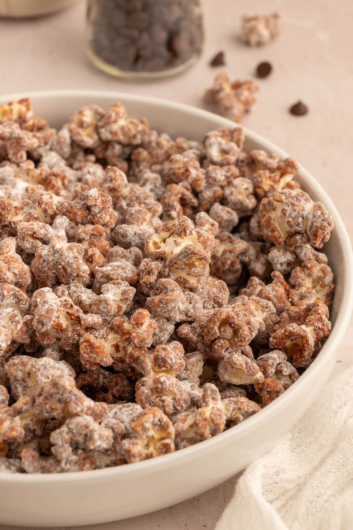 Close up of a ceramic bowl full of chocolate peanut butter popcorn.
