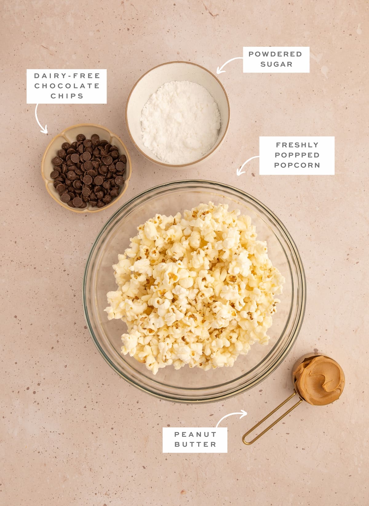 Chocolate peanut butter popcorn recipe ingredients with white labels.