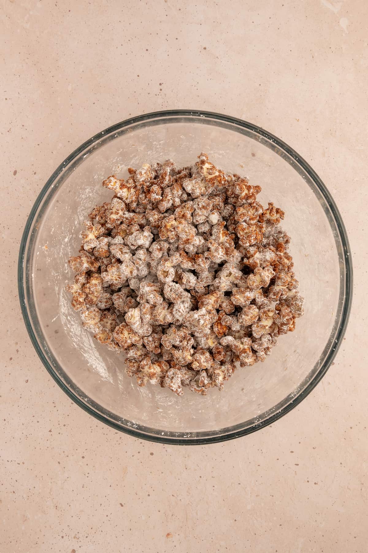 Powdered sugar fully incorporated into the popcorn mixture.