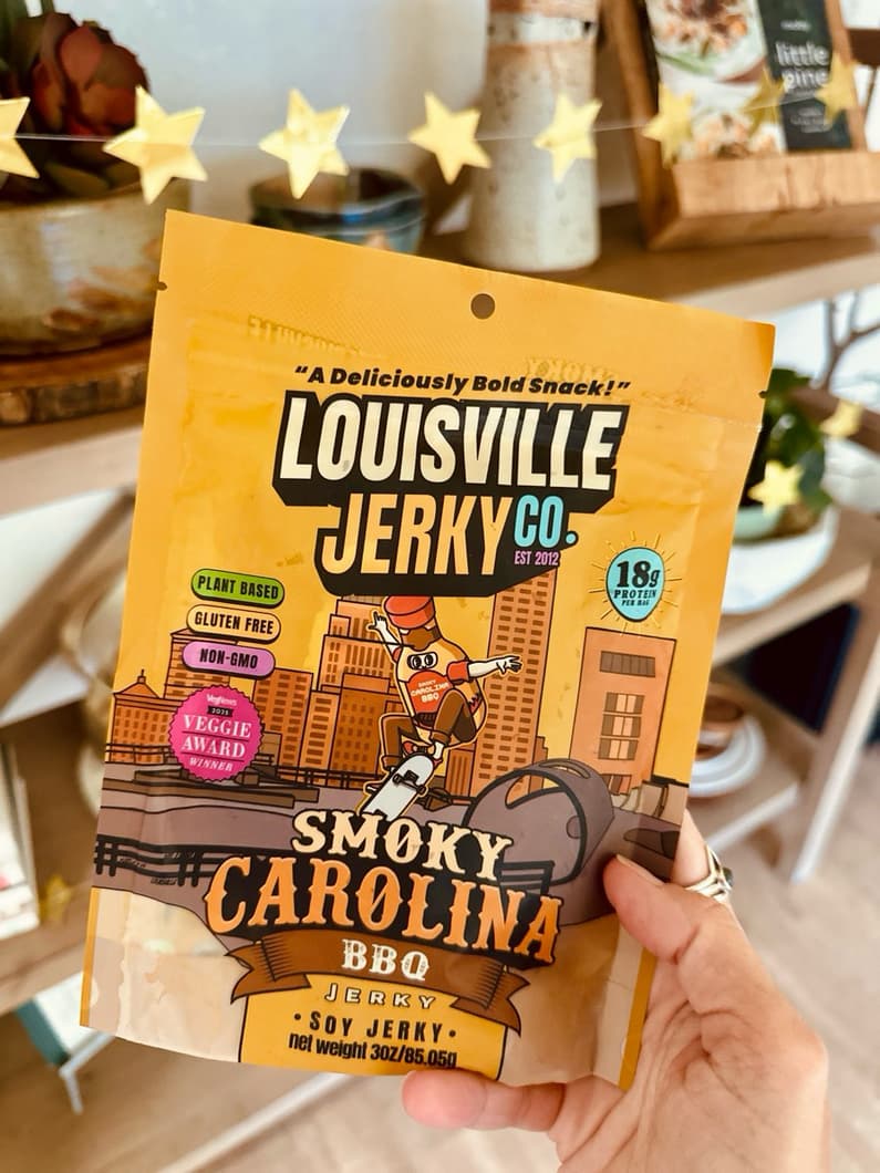 hand holding out Louisville vegan jerky