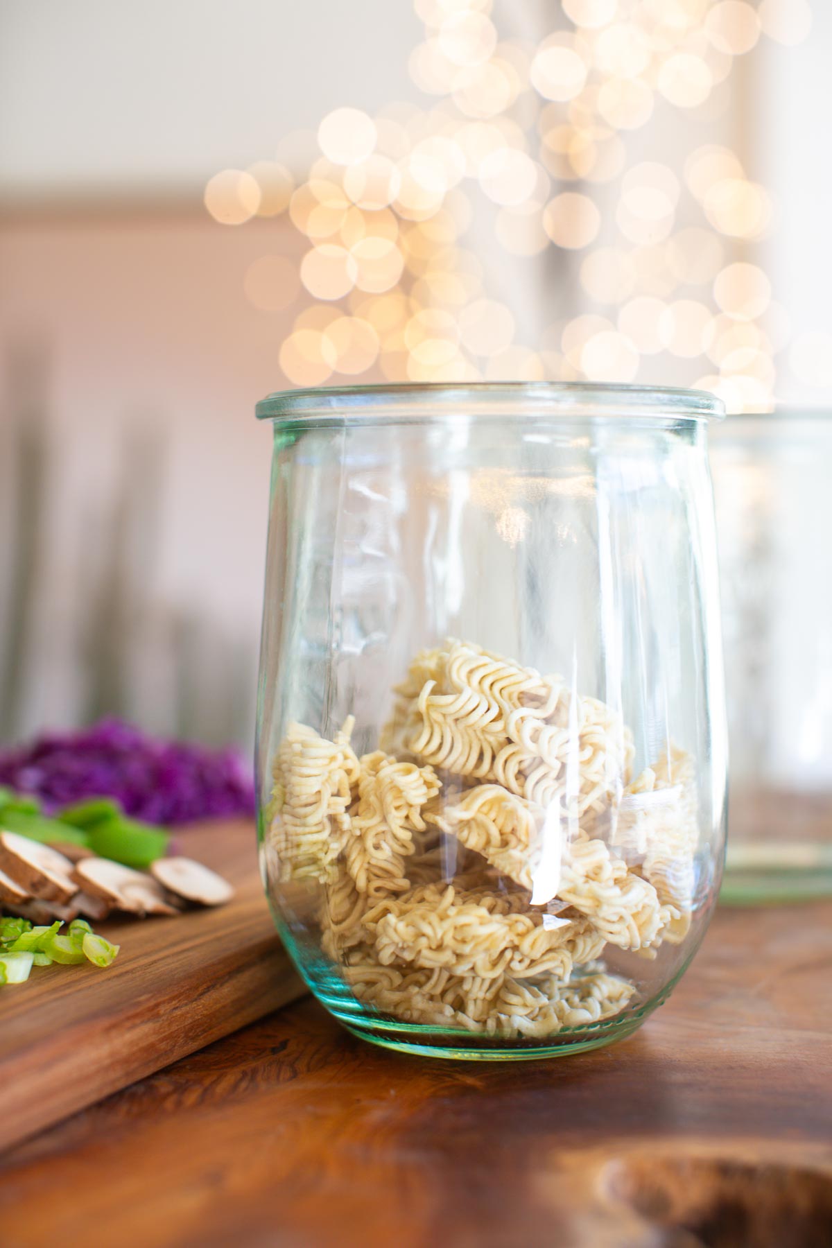 Dry ramen noodles in a glass jar.