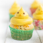A vegan Easter cupcake with lemon buttercream frosting decorated like a chick peep.