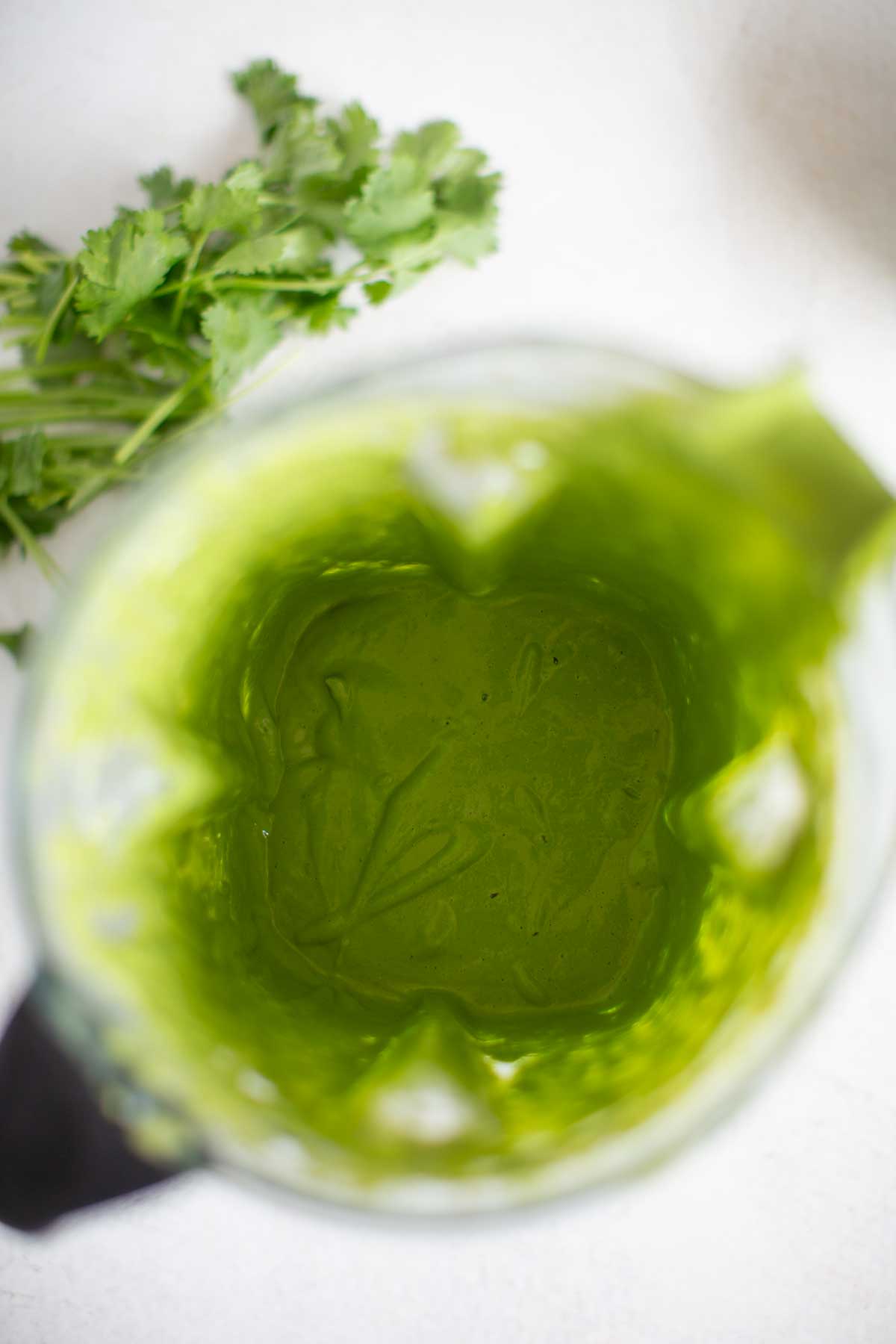 A top view of a cilantro tahini dressing ingredients blended.