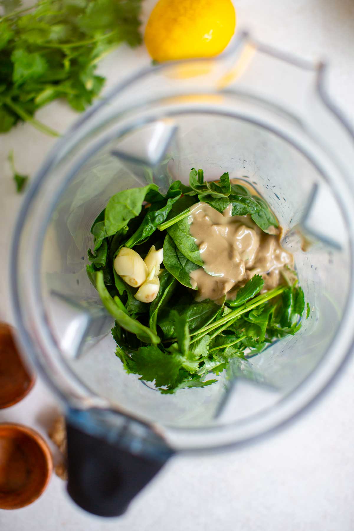 Ingredients for a cilantro tahini dressing in a blender.