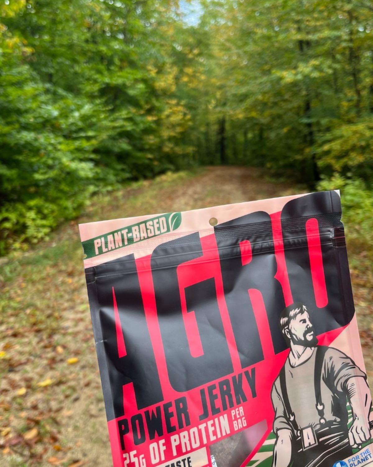 A bag of Agro power plant-based jerky outside in the wilderness.