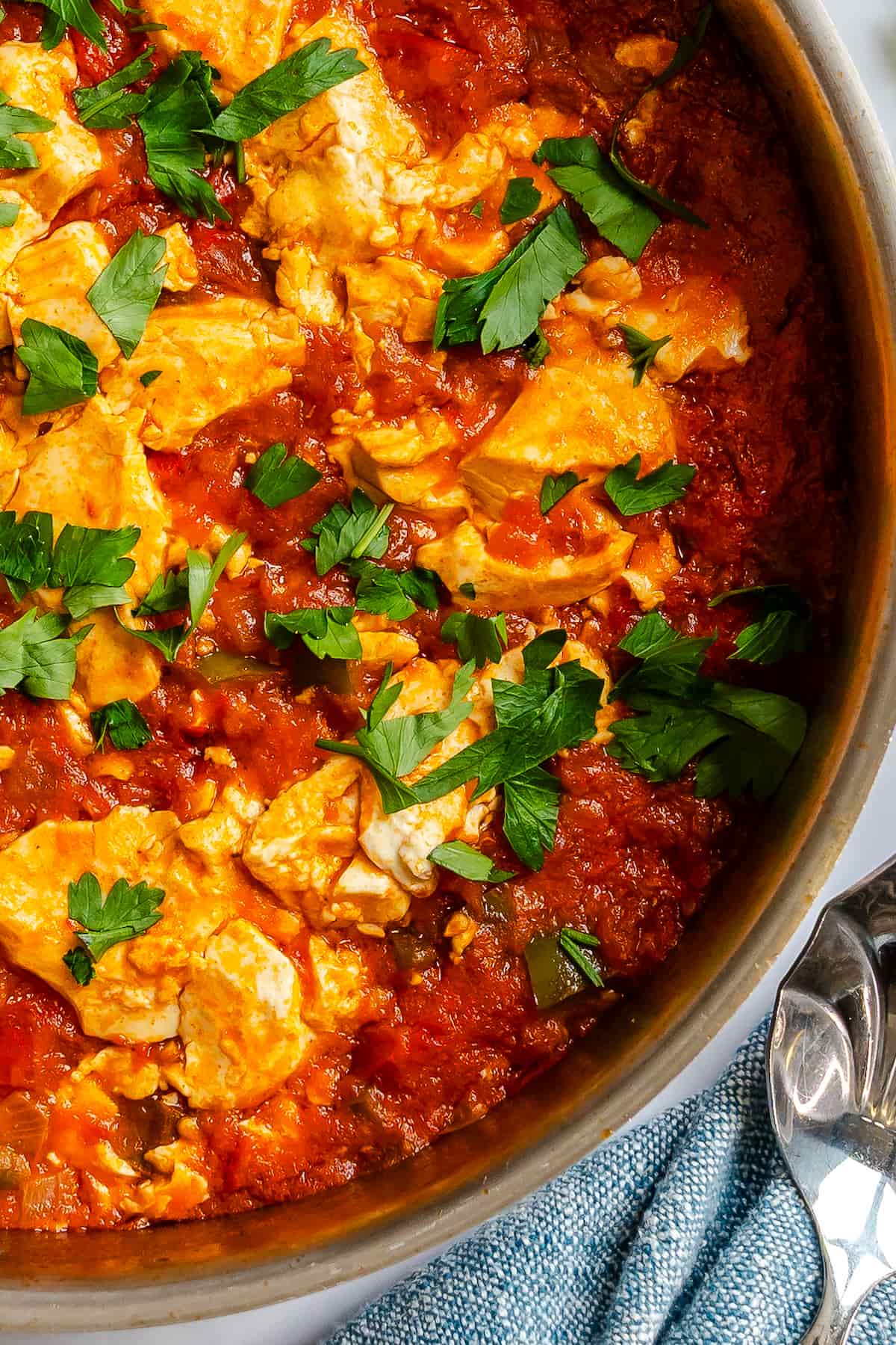 Close up of this tomato silken tofu vegan shakshuka recipe in a skillet.