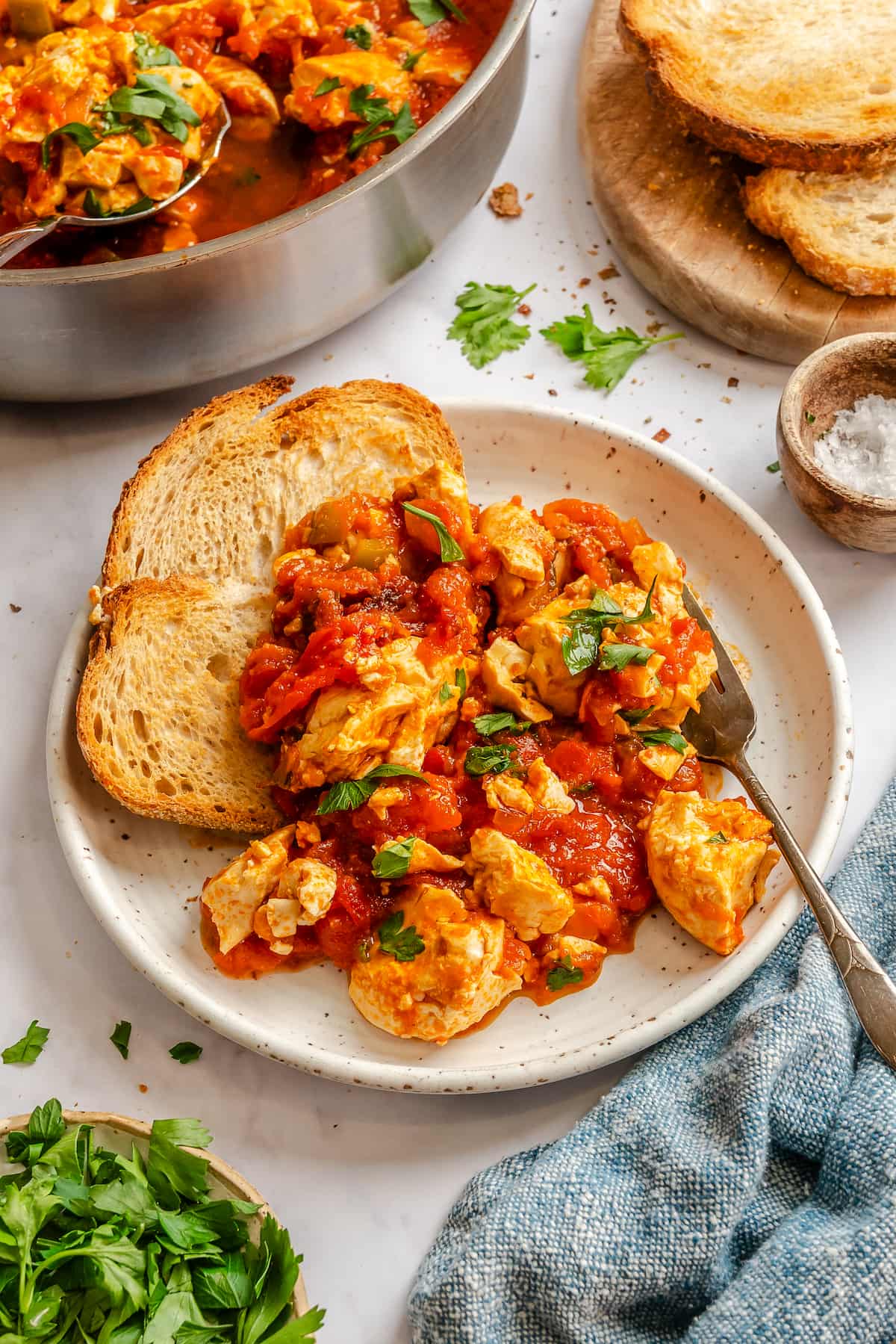 A plate with silken tofu vegan shakshuka and two slices of toast.